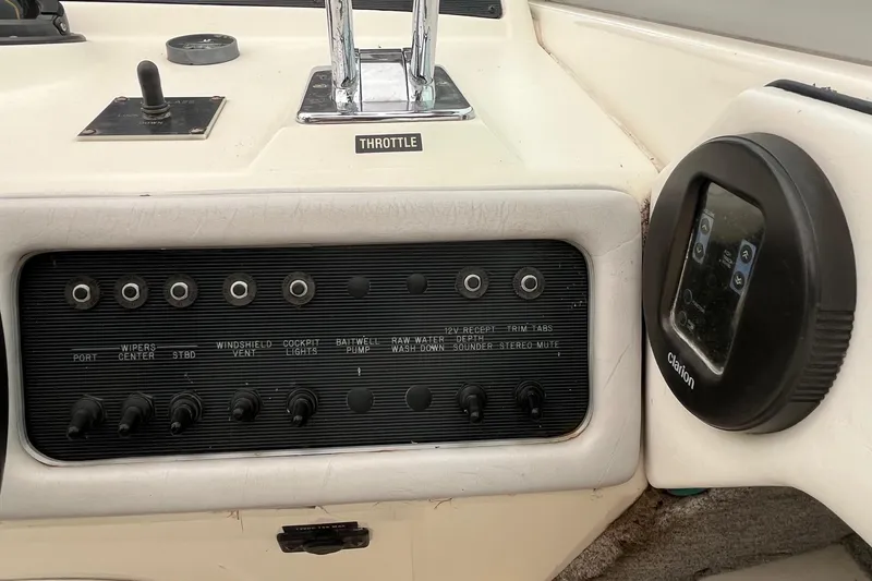 Slide: The Image of Control panel of a 1994 Sea Ray 310 Amberjack boat with switches and Clarion audio system. - 15