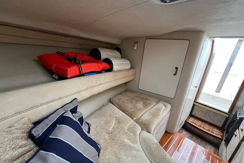 Slide: The Image of Interior cabin of 1994 Sea Ray 310 Amberjack with cushions and life jackets. - 26