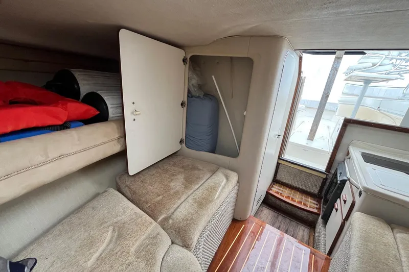 Slide: The Image of Interior cabin of a 1994 Sea Ray 310 Amberjack boat with storage and seating. - 27