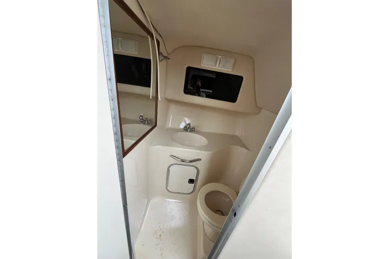 Slide: The Image of Interior of 1994 Sea Ray 310 Amberjack boat bathroom with sink and toilet. - 29