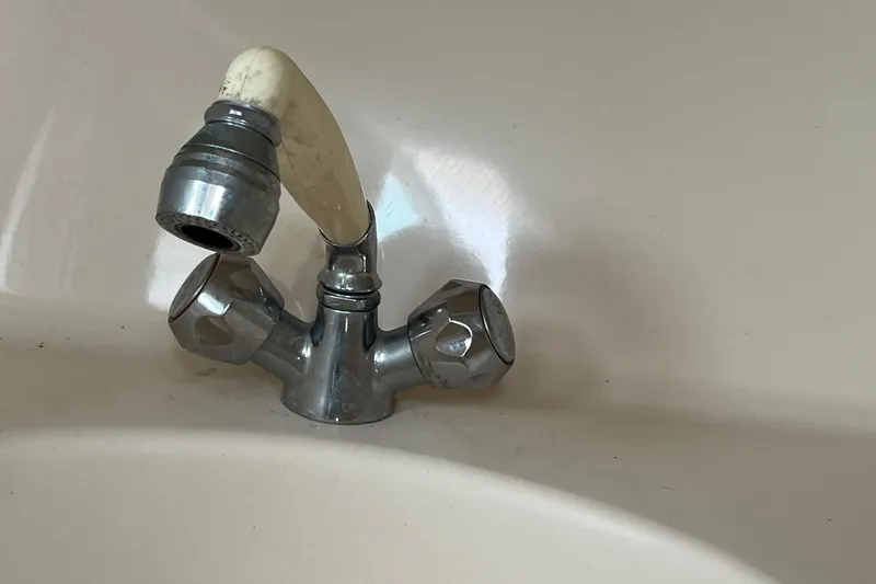 Slide: The Image of Old dual-handle faucet in a Sea Ray 310 Amberjack boat, 1994 model. - 30