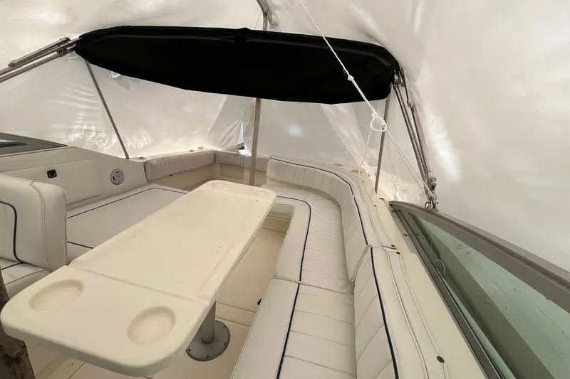 Slide: The Image of Interior of 1994 Sea Ray 310 Amberjack boat with white seating and table. - 7
