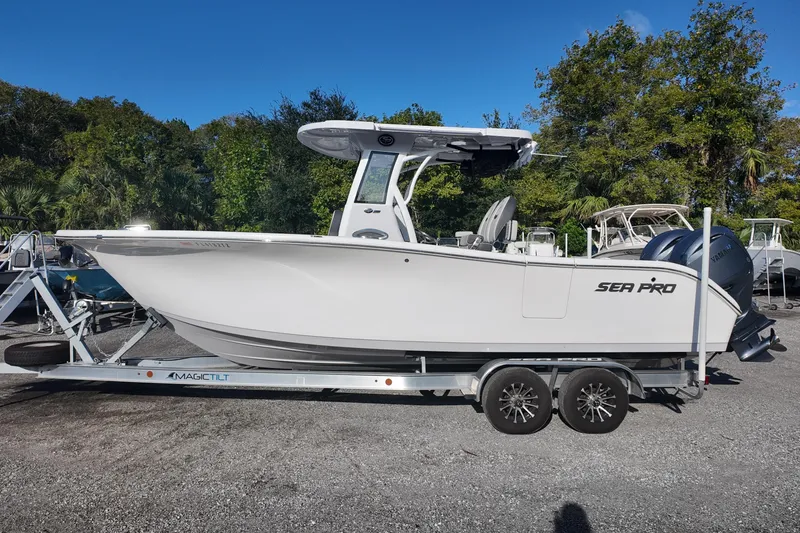 The Image of 2025 Sea Pro 262 Offshore boat on trailer, parked outdoors, side view. - 0