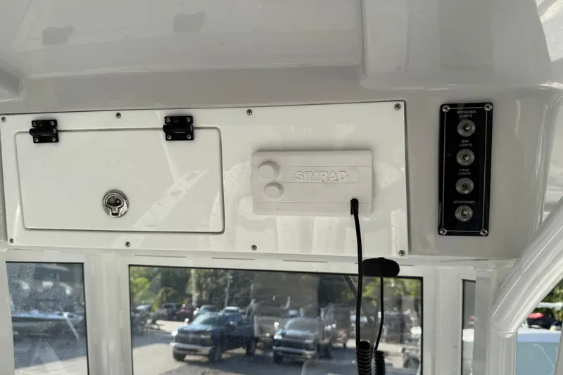 Slide: The Image of 2025 Sea Pro 262 Offshore boat dashboard with Simrad system and control panel. - 10