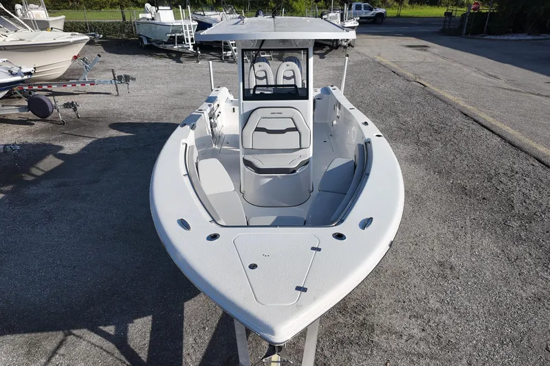 Slide: The Image of 2025 Sea Pro 262 Offshore boat, sleek design, parked on a lot with other boats. - 13