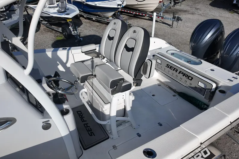 Slide: The Image of 2025 Sea Pro 262 Offshore boat interior with dual seats and steering wheel. - 16