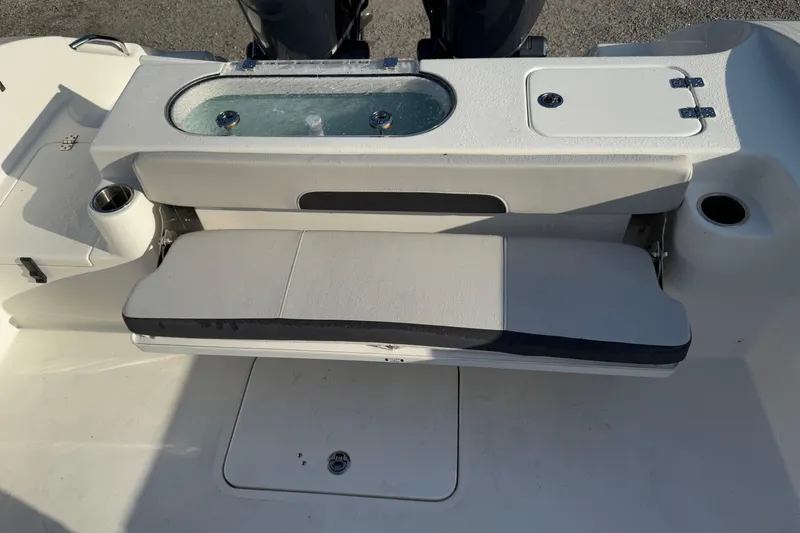 Slide: The Image of 2025 Sea Pro 262 Offshore boat seating and storage area with livewell. - 19