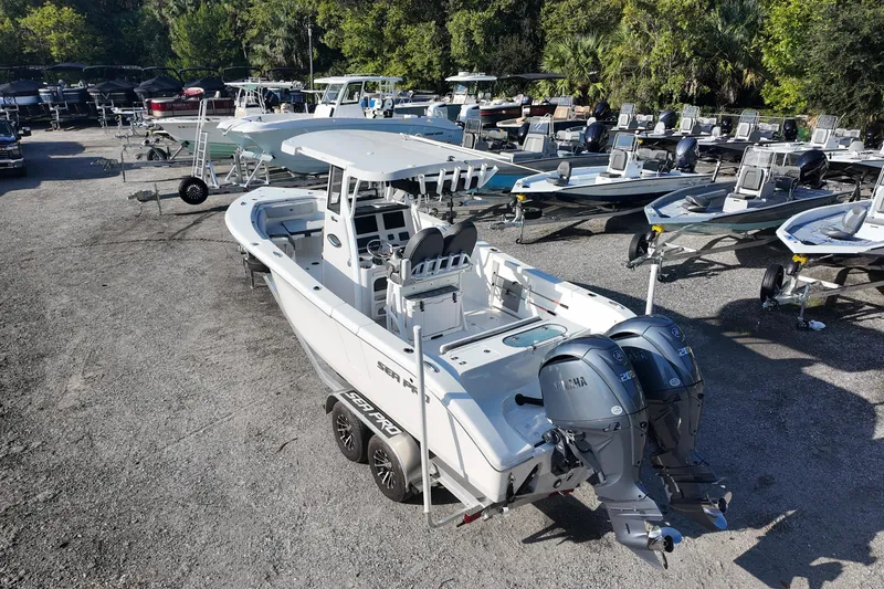 Slide: The Image of 2025 Sea Pro 262 Offshore boat with dual engines in a marina setting. - 5