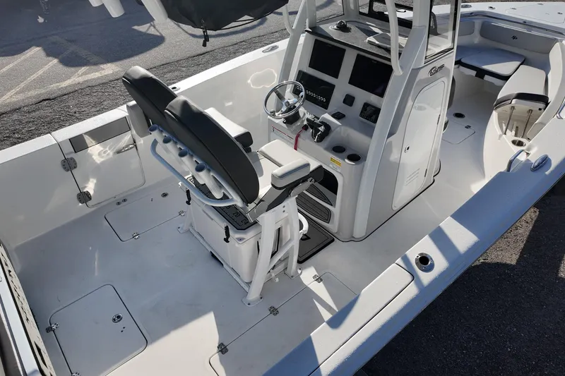 Slide: The Image of 2025 Sea Pro 262 Offshore boat interior with helm, seating, and storage compartments. - 8