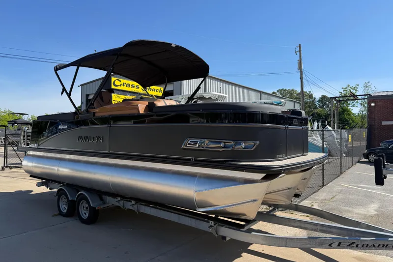 The Image of 2026 Avalon Catalina Quad Lounge 23' pontoon boat on trailer, outdoor display. - 0