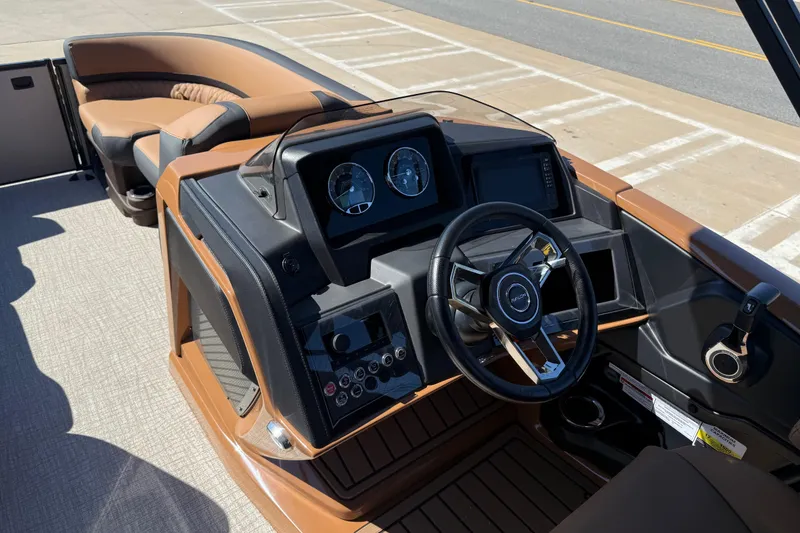 Slide: The Image of 2026 Avalon Catalina Quad Lounge boat interior with modern dashboard and steering wheel. - 15