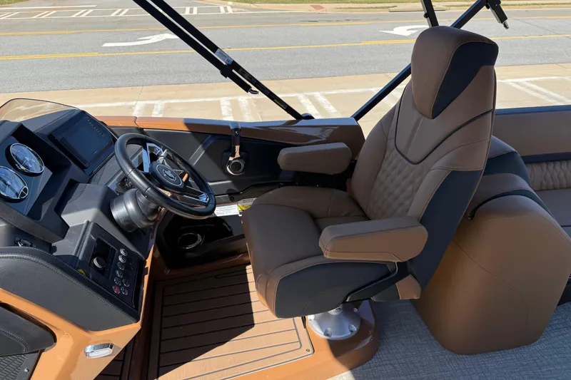 Slide: The Image of Captain's chair and dashboard of 2026 Avalon Catalina Quad Lounge boat. - 16