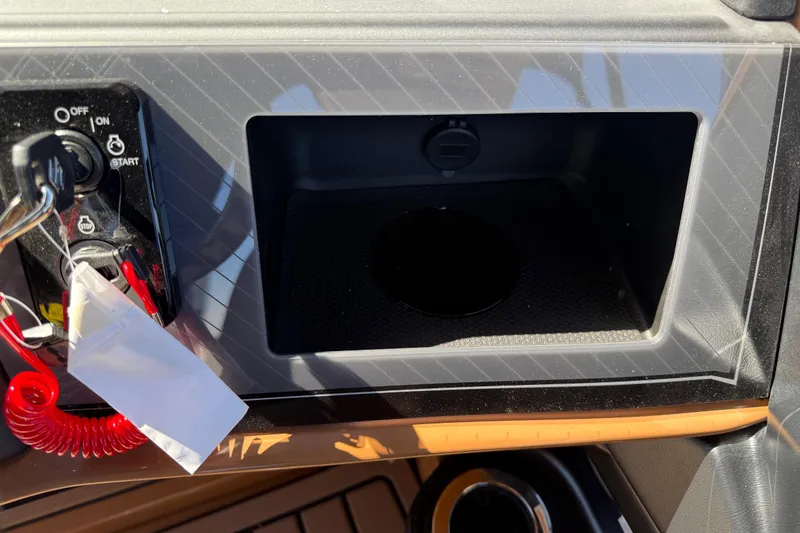 Slide: The Image of Control panel of 2026 Avalon Catalina Quad Lounge boat with ignition switch and storage compartment. - 20