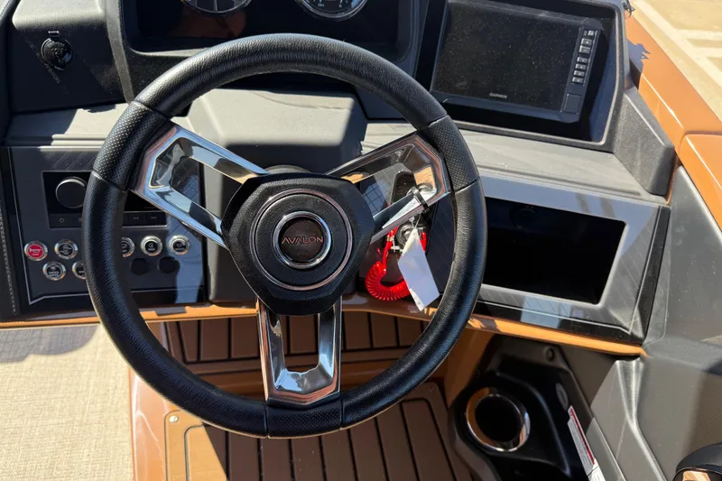 Slide: The Image of Steering wheel of 2026 Avalon Catalina Quad Lounge boat with modern dashboard controls. - 22