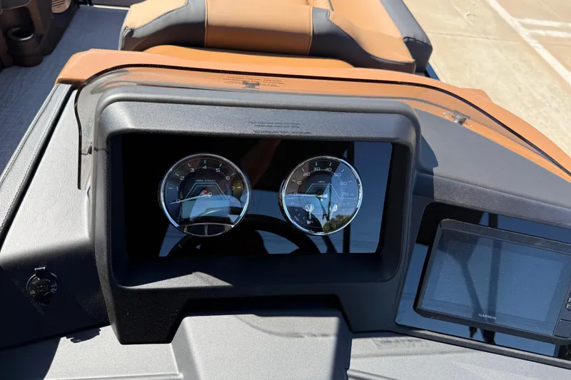 Slide: The Image of Dashboard of 2026 Avalon Catalina Quad Lounge boat with gauges and Garmin display. - 23