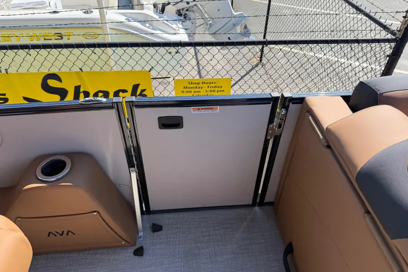 Slide: The Image of 2026 Avalon Catalina Quad Lounge interior with tan seating and gate, docked at marina. - 28