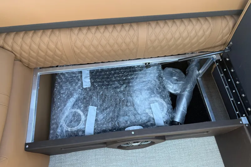 Slide: The Image of Storage compartment in 2026 Avalon Catalina Quad Lounge boat with bubble-wrapped items. - 32