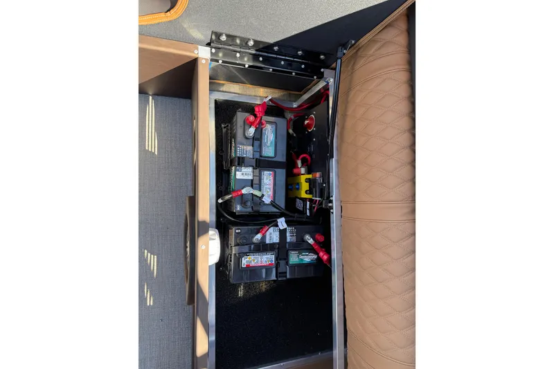 Slide: The Image of 2026 Avalon Catalina Quad Lounge battery compartment with multiple batteries and wiring. - 34