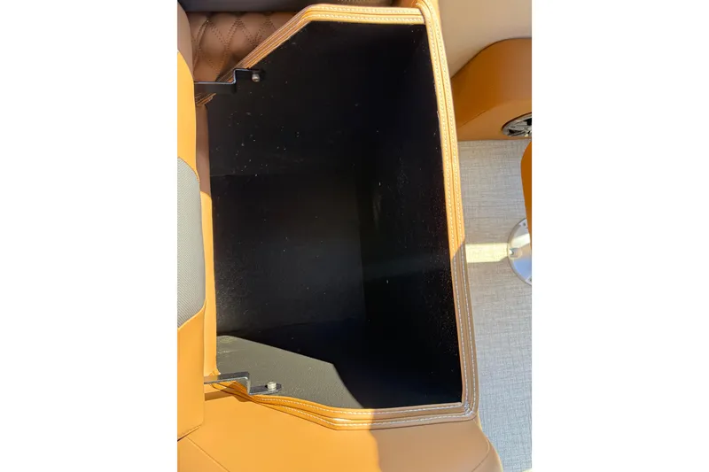 Slide: The Image of Storage compartment in 2026 Avalon Catalina Quad Lounge boat, featuring tan leather interior. - 36