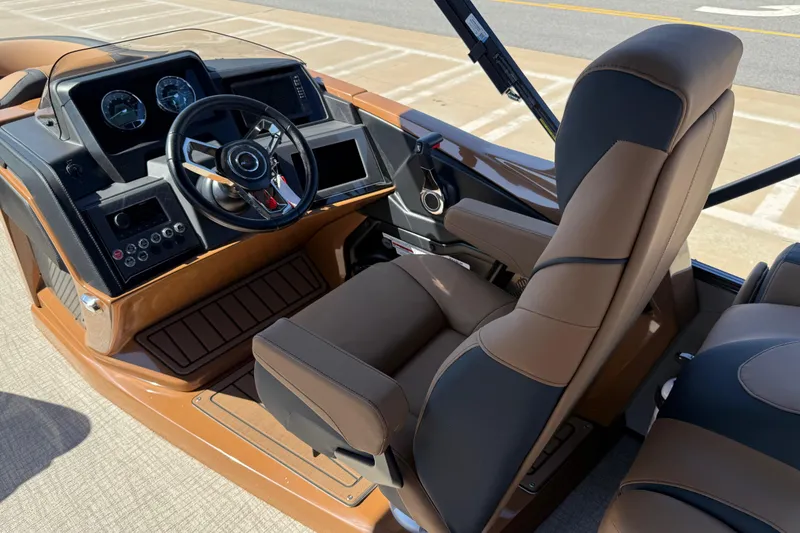 Slide: The Image of 2026 Avalon Catalina Quad Lounge boat interior with modern dashboard and comfortable seating. - 46
