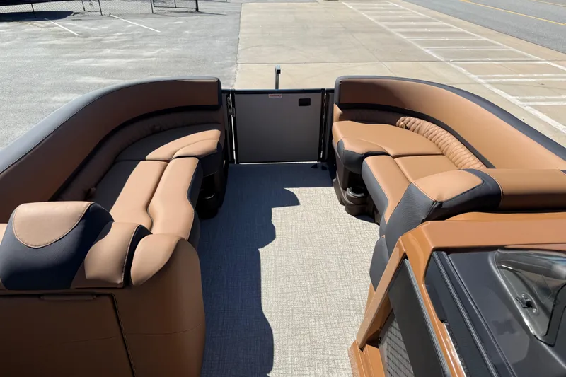Slide: The Image of 2026 Avalon Catalina Quad Lounge 23' interior with luxurious tan seating and spacious layout. - 47