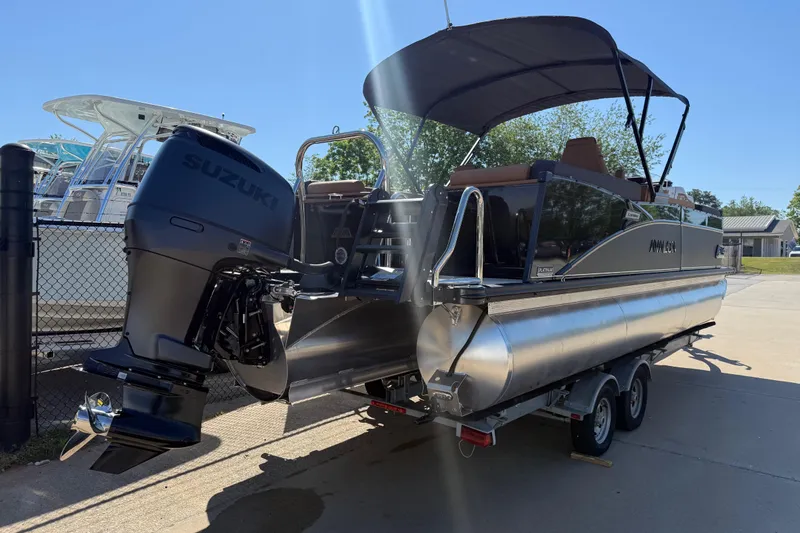 Slide: The Image of 2026 Avalon Catalina Quad Lounge 23' pontoon boat with Suzuki outboard motor on trailer. - 5