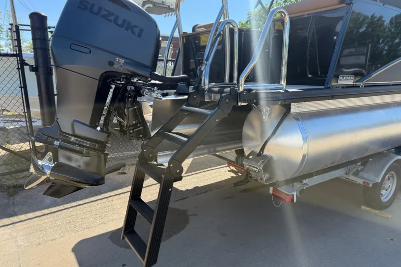 Slide: The Image of 2026 Avalon Catalina Quad Lounge boat with Suzuki outboard motor and ladder. - 7