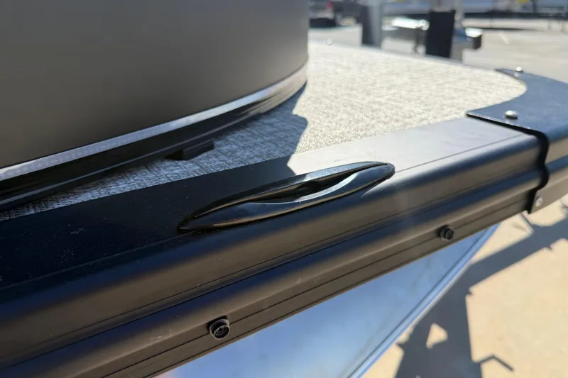 Slide: The Image of 2026 Avalon Catalina Quad Lounge boat detail, featuring sleek black railing and textured flooring. - 8