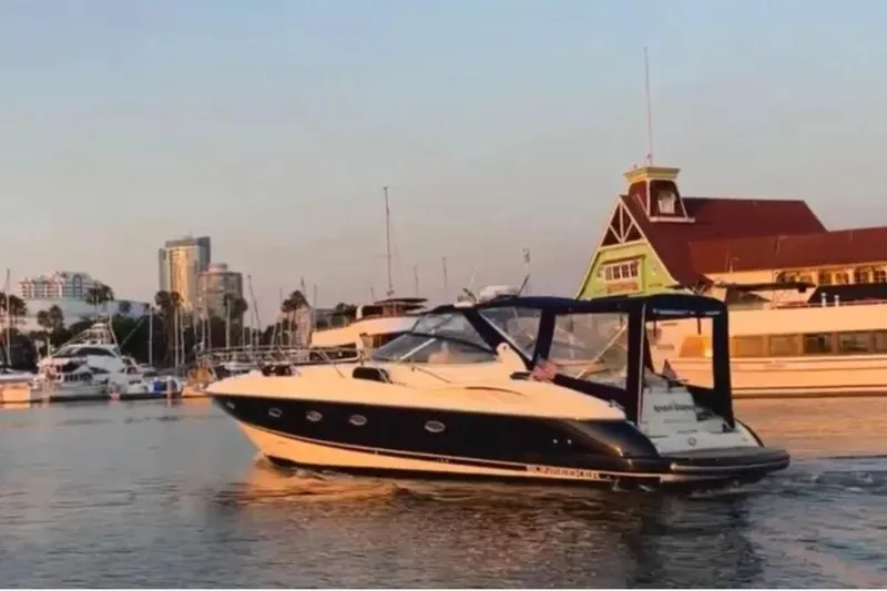 The Image of 2007 Chaparral Signature 350 yacht cruising in a marina at sunset. - 1