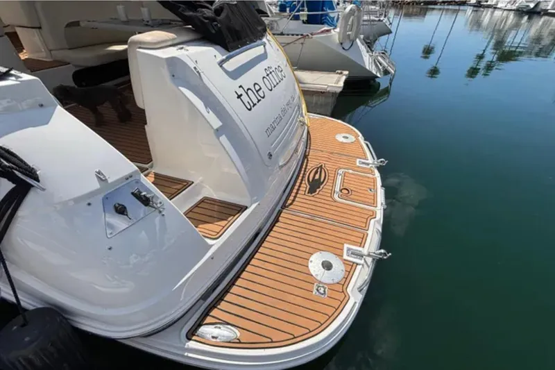 Slide: The Image of 2007 Chaparral Signature 350 yacht docked, featuring teak swim platform and marina view. - 3