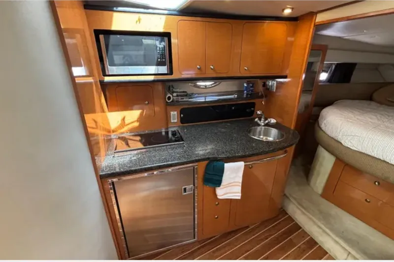 Slide: The Image of 2007 Chaparral Signature 350 yacht interior with kitchenette and cozy sleeping area. - 8