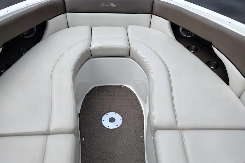 Slide: The Image of Interior seating of a 2013 Sea Ray 300 SLX boat, featuring beige upholstery. - 10