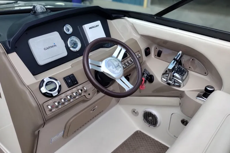 Slide: The Image of Interior dashboard of a 2013 Sea Ray 300 SLX boat with Garmin and Mercury controls. - 11