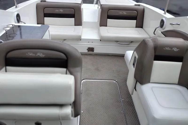 Slide: The Image of Interior of a 2013 Sea Ray 300 SLX boat with cushioned seating and carpeted flooring. - 12