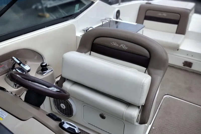 Slide: The Image of 2013 Sea Ray 300 SLX boat interior with steering wheel and seating. - 14