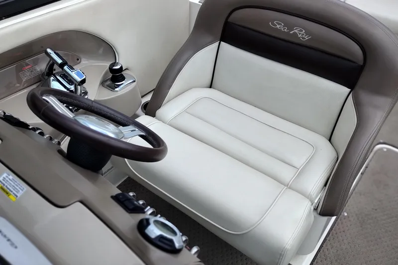 Slide: The Image of Captain's seat and controls of a 2013 Sea Ray 300 SLX boat. - 15