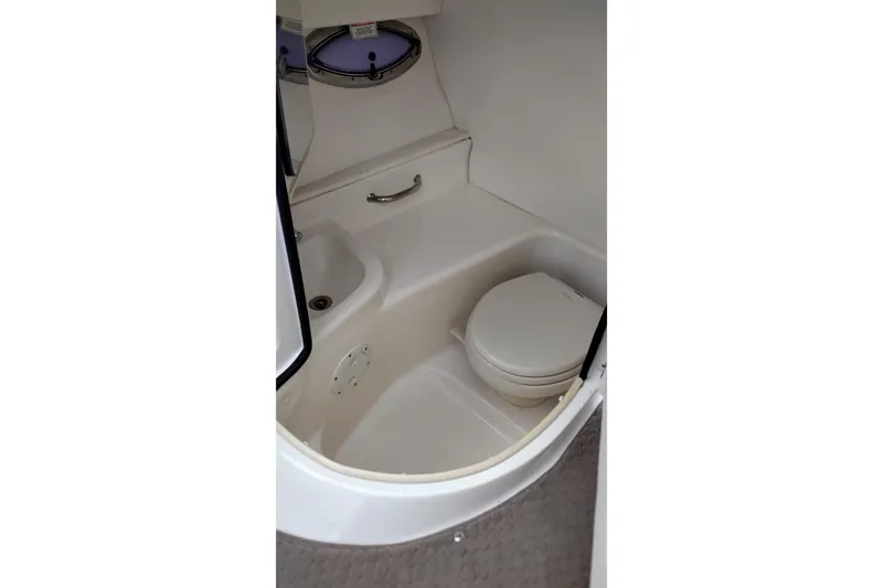 Slide: The Image of 2013 Sea Ray 300 SLX boat interior with compact marine toilet. - 18