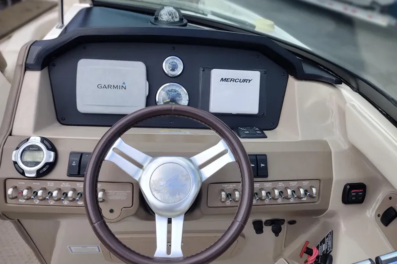 Slide: The Image of Dashboard of a 2013 Sea Ray 300 SLX boat with Garmin and Mercury displays. - 21