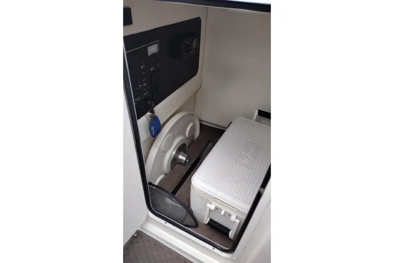 Slide: The Image of Interior of 2013 Sea Ray 300 SLX boat with control panel and cooler. - 22