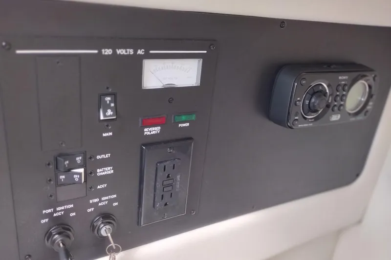 Slide: The Image of Control panel of a 2013 Sea Ray 300 SLX boat with electrical switches and outlets. - 23
