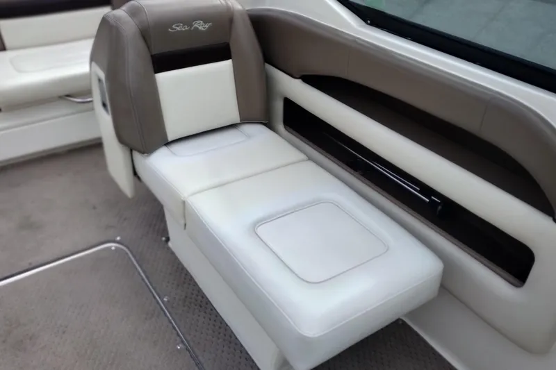 Slide: The Image of 2013 Sea Ray 300 SLX boat interior with beige and brown seating. - 25