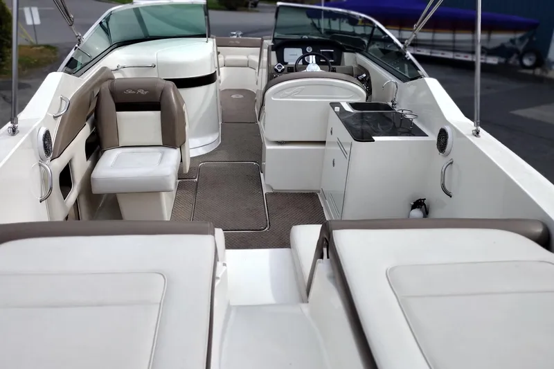 Slide: The Image of 2013 Sea Ray 300 SLX boat interior with seating, helm, and kitchenette. - 30