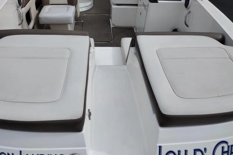 Slide: The Image of Interior view of a 2013 Sea Ray 300 SLX boat, featuring cushioned seating and deck area. - 31