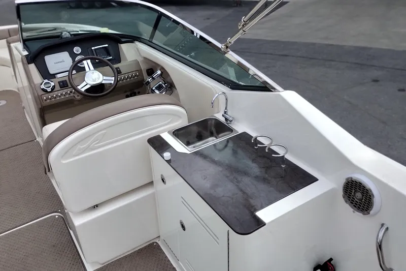 Slide: The Image of 2013 Sea Ray 300 SLX boat interior with helm, sink, and countertop. - 32