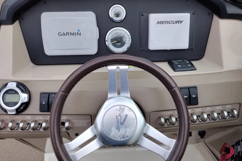 Slide: The Image of Steering console of 2013 Sea Ray 300 SLX with Garmin and Mercury displays. - 34