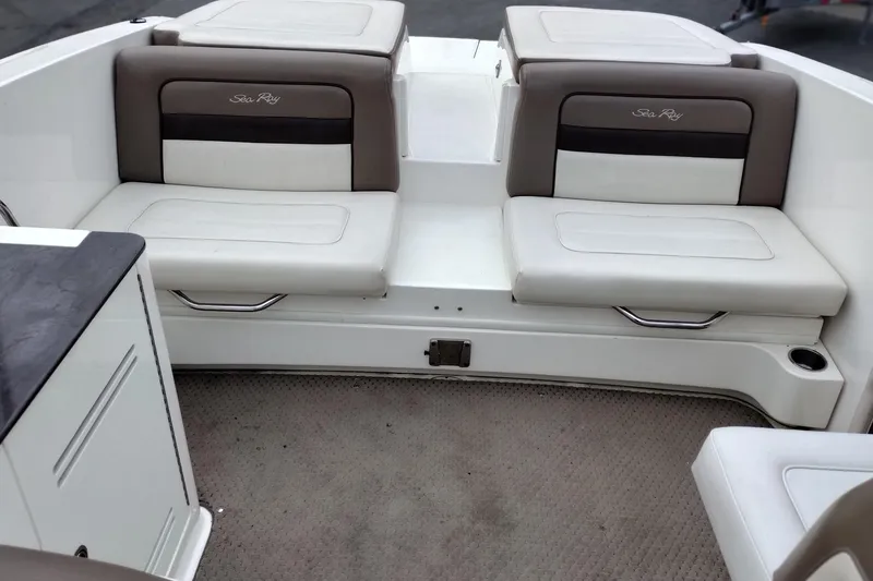 Slide: The Image of Interior seating of a 2013 Sea Ray 300 SLX boat, featuring cushioned benches. - 35