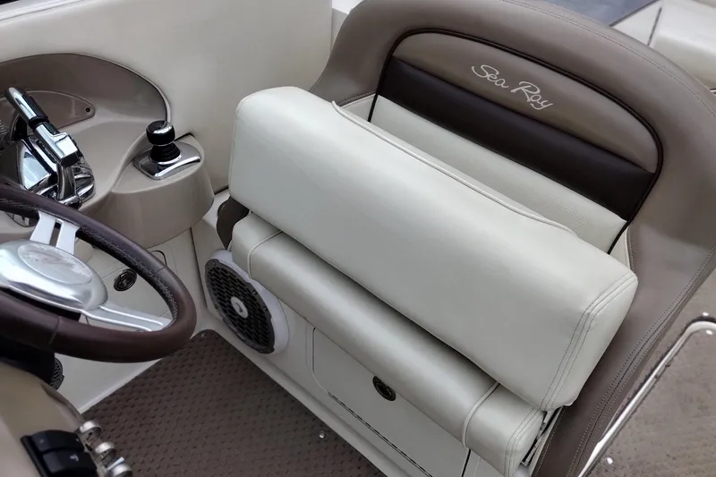 Slide: The Image of 2013 Sea Ray 300 SLX boat interior with steering wheel and beige seating. - 36