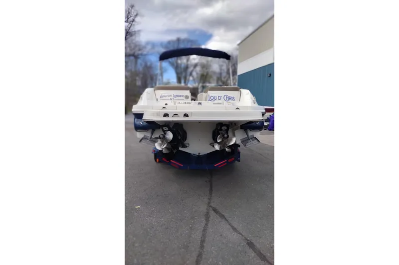 Slide: The Image of Rear view of a 2013 Sea Ray 300 SLX boat parked outdoors. - 4