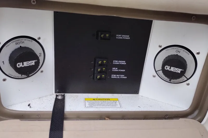 Slide: The Image of Control panel of a 2013 Sea Ray 300 SLX boat with power switches and dials. - 44