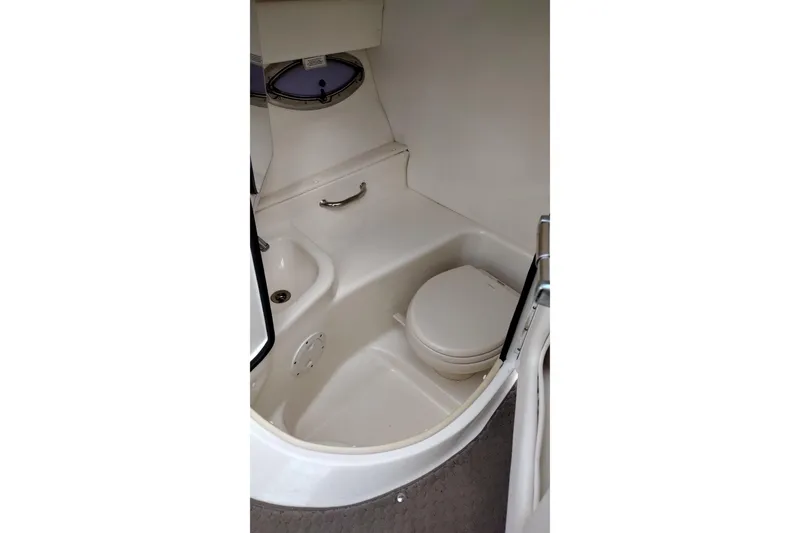 Slide: The Image of Interior of 2013 Sea Ray 300 SLX boat featuring a compact marine toilet. - 45